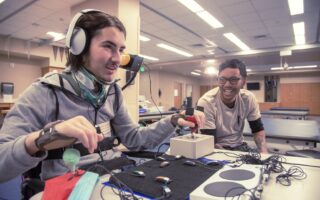 Person playing videogames with special accessible controllers